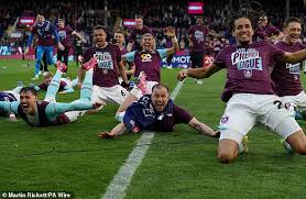 Burnley supporters rush onto the touchline